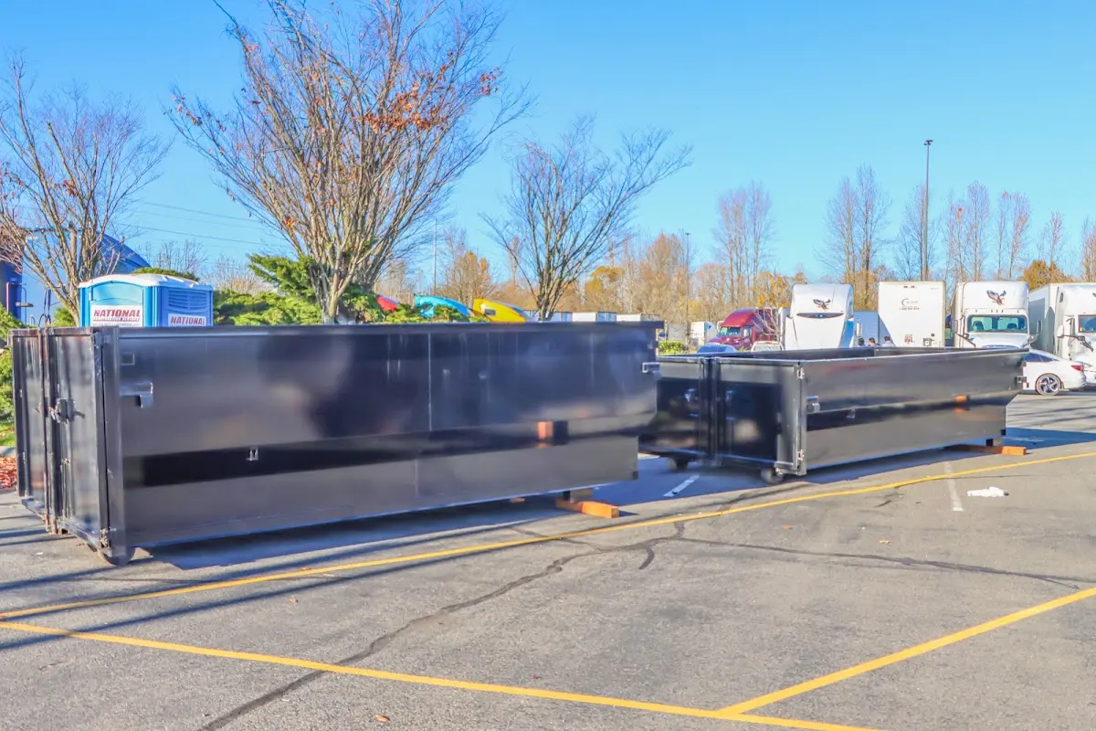 Professional dumpster rental service with roll-off container on residential driveway in Fort Payne